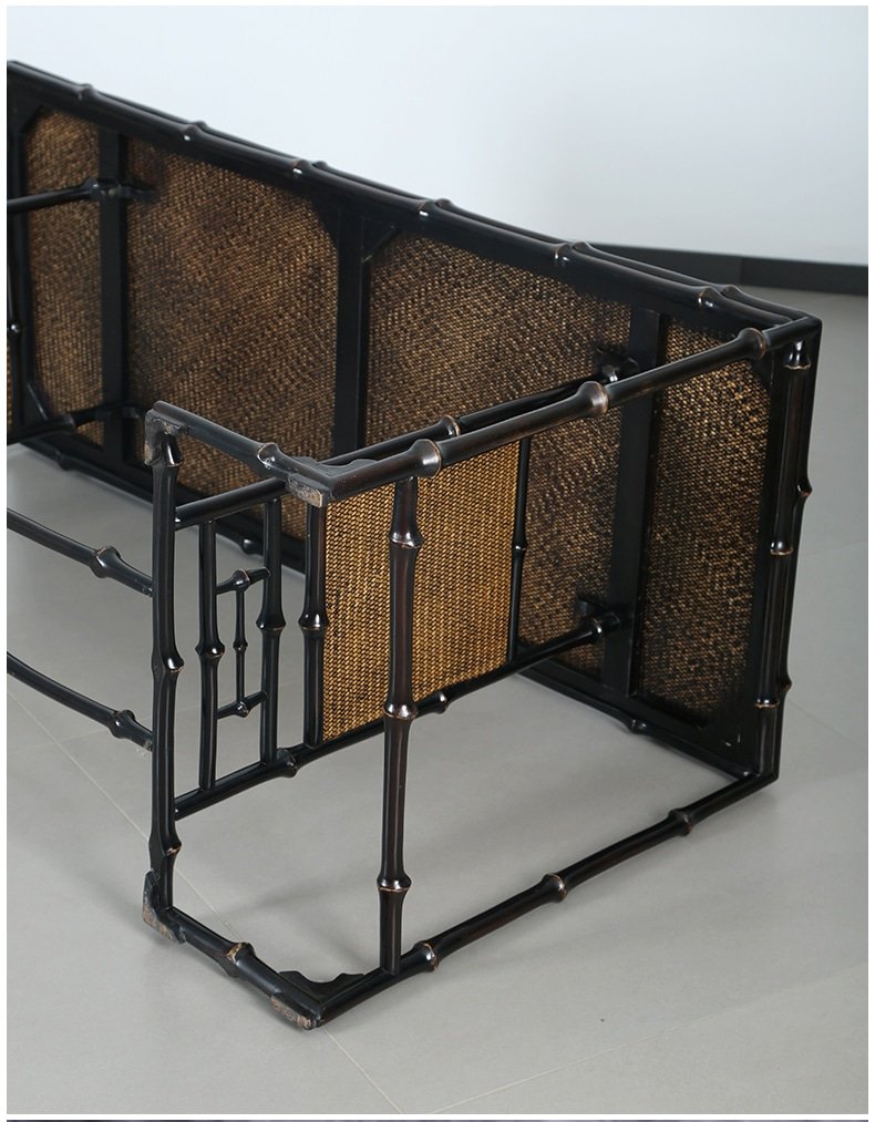 An overturned bamboo table for tea, part of the Handmade Chinese Qiongzhu Furniture collection, is showcased on a light gray floor. This piece features a black metal and woven rattan construction with an intricate interconnected frame design, showcasing rectangular patterns and a modern aesthetic that resembles the elegance of traditional Chinese craftsmanship.
